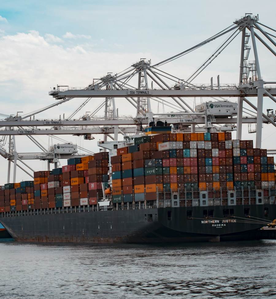 Container cranes loading a cargo ship at port